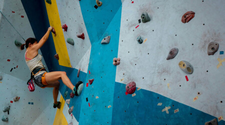 person climbing indoor rock wall without ropes or a belay, innovative portfolios perspectives