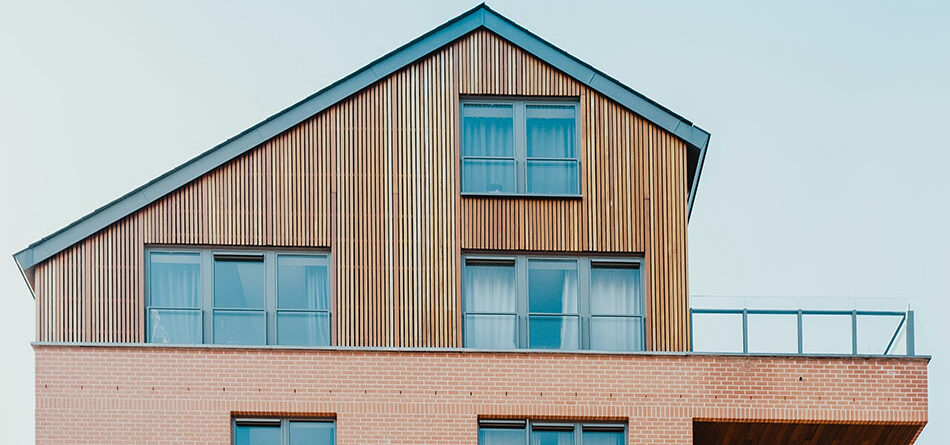 side of a house, the bottom half is sided with bricks and the top half is sided with skinny wooden panels, innovative portfolios perspectives