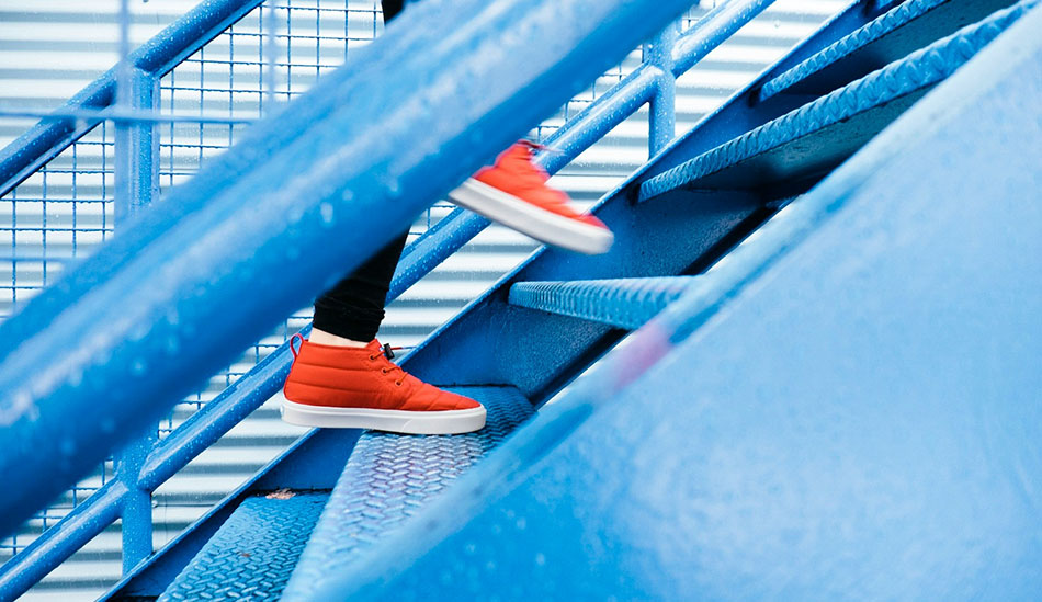 close-up of red sneakers going up a blue staircase, innovative portfolios perspectives