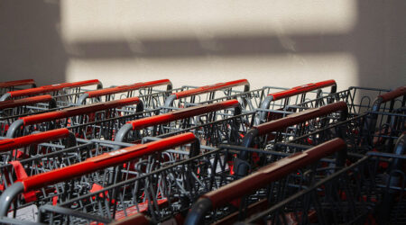 close up of shopping carts stacked up against a white wall