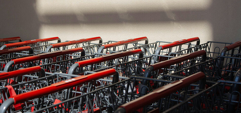 close up of shopping carts stacked up against a white wall